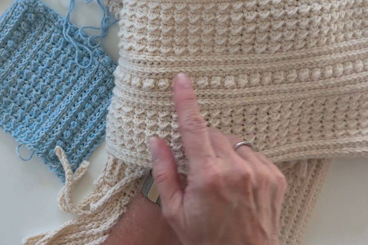 Blue practice swatch next to the finished cream Berry Ridge crochet scarf