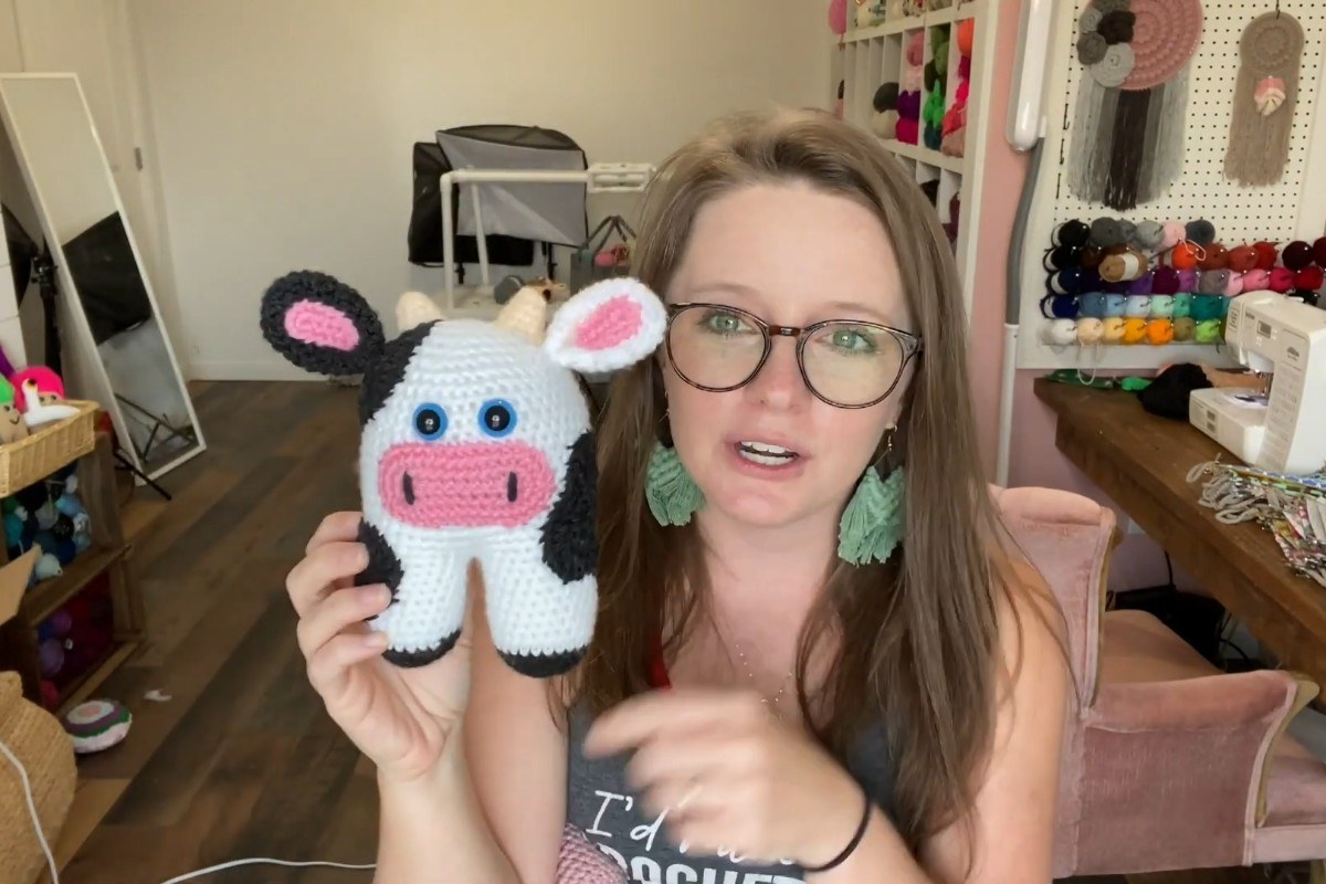 Finished crochet amigurumi cow with pink snout and gray patches by A Crafty Concept
