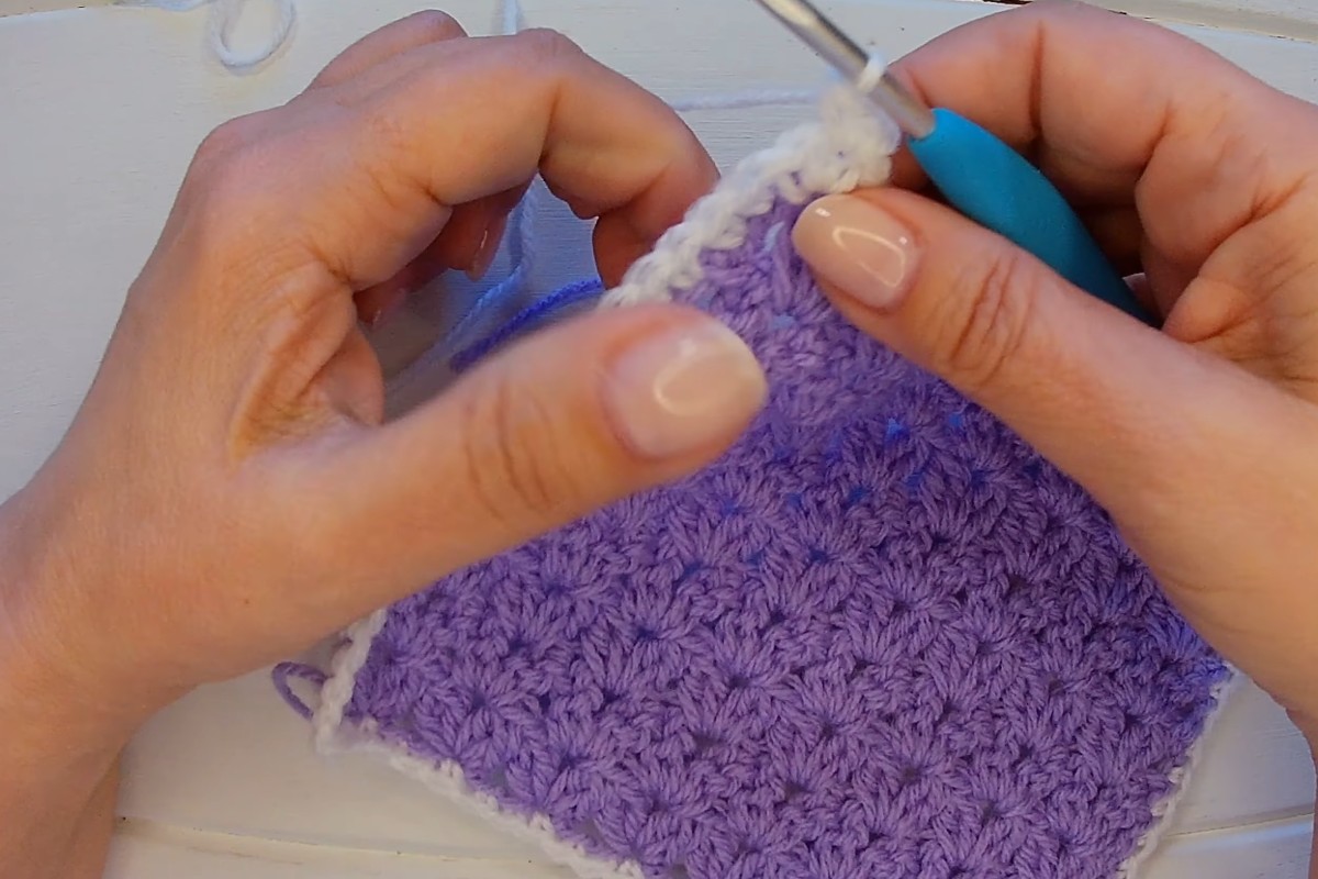 Adding a white single crochet border to the V cluster stitch blanket