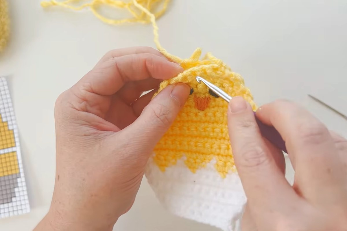 Joining the front and back pieces of the crochet refillable chick egg