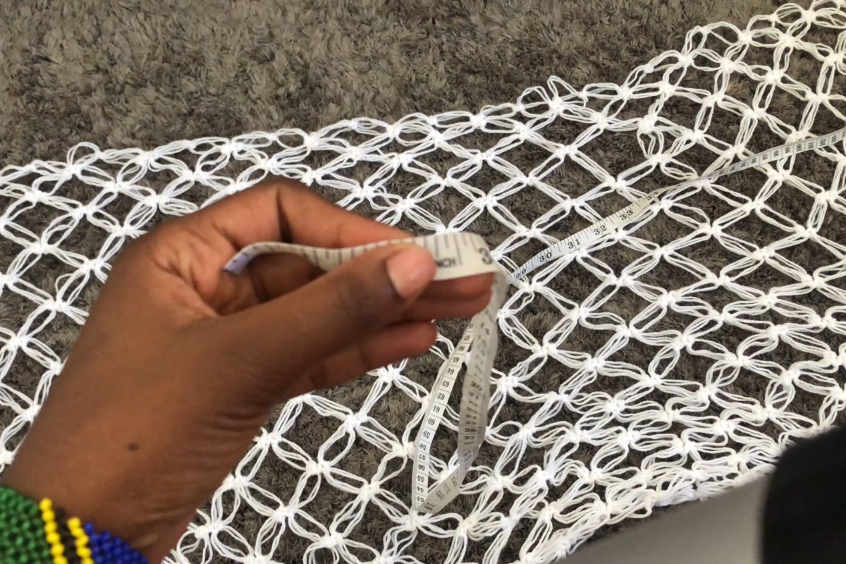 Measuring the back panel of the crochet mesh kimono