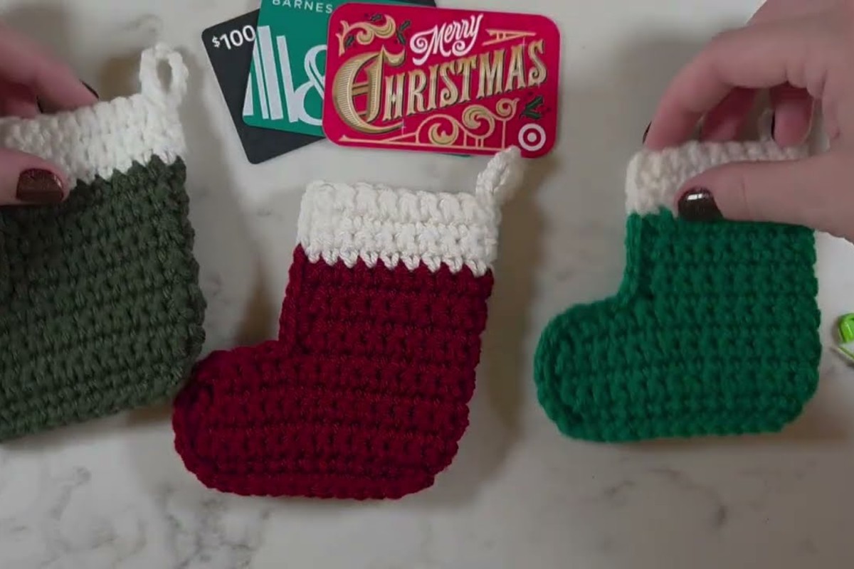 Three finished crochet mini Christmas stockings shown next to gift cards
