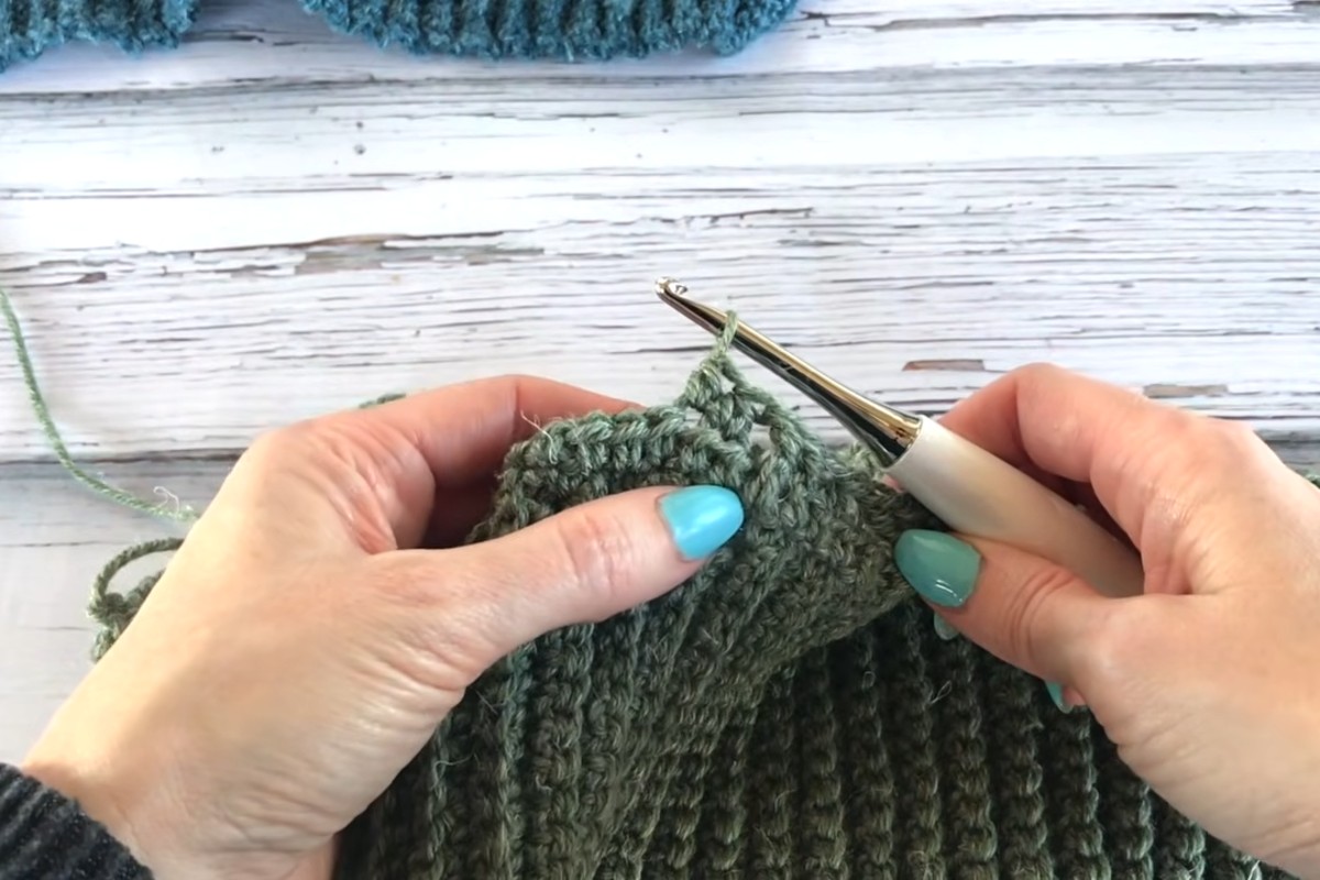 Working the front post cables of the men's crochet sweater