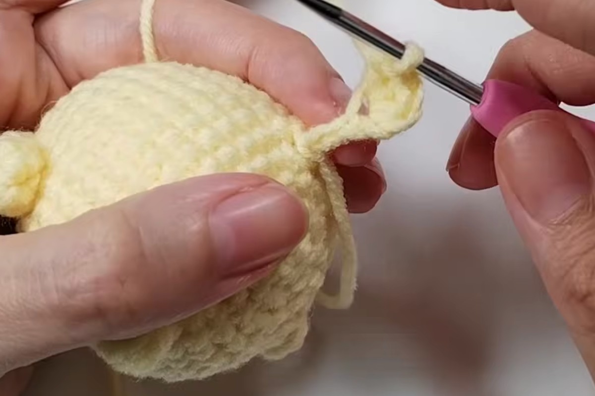 Crocheting the little tail of the pudding pup amigurumi