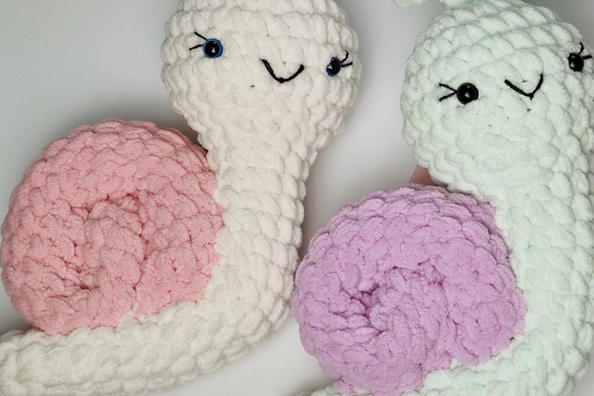 Two finished plush snail amigurumi with pink and lilac shells by Hobbi CROCHET