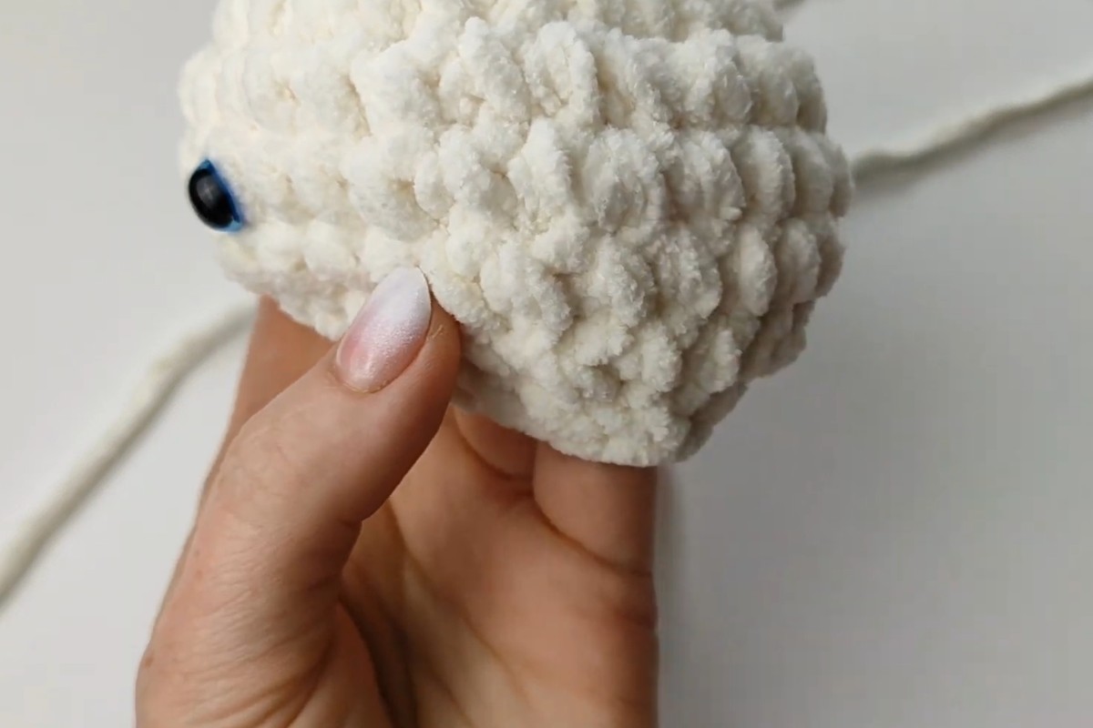 Plush snail amigurumi head with safety eye in progress