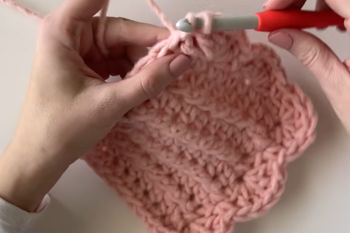 Working the shell stitch border on the Sweet Lines crochet baby blanket