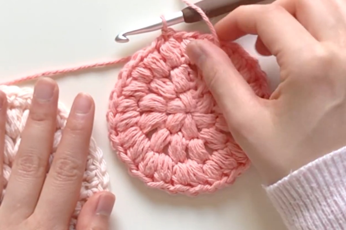 Puff stitch rounds of a pink crochet face scrubby by Sweet Softies