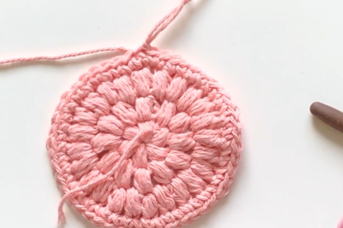 Finished pink crochet face scrubby with a hanging loop by Sweet Softies
