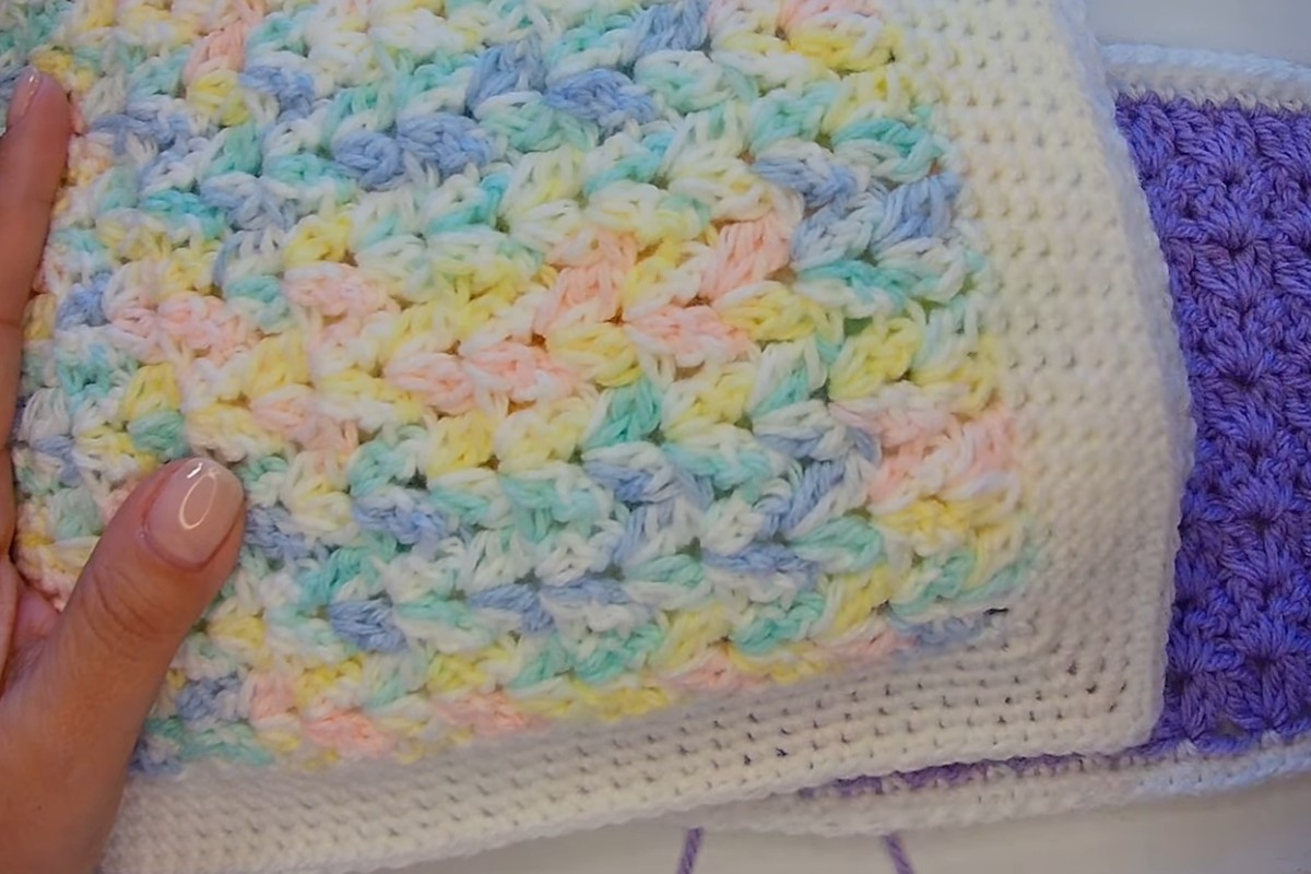 Close-up of the V cluster stitch texture in pastel baby yarn