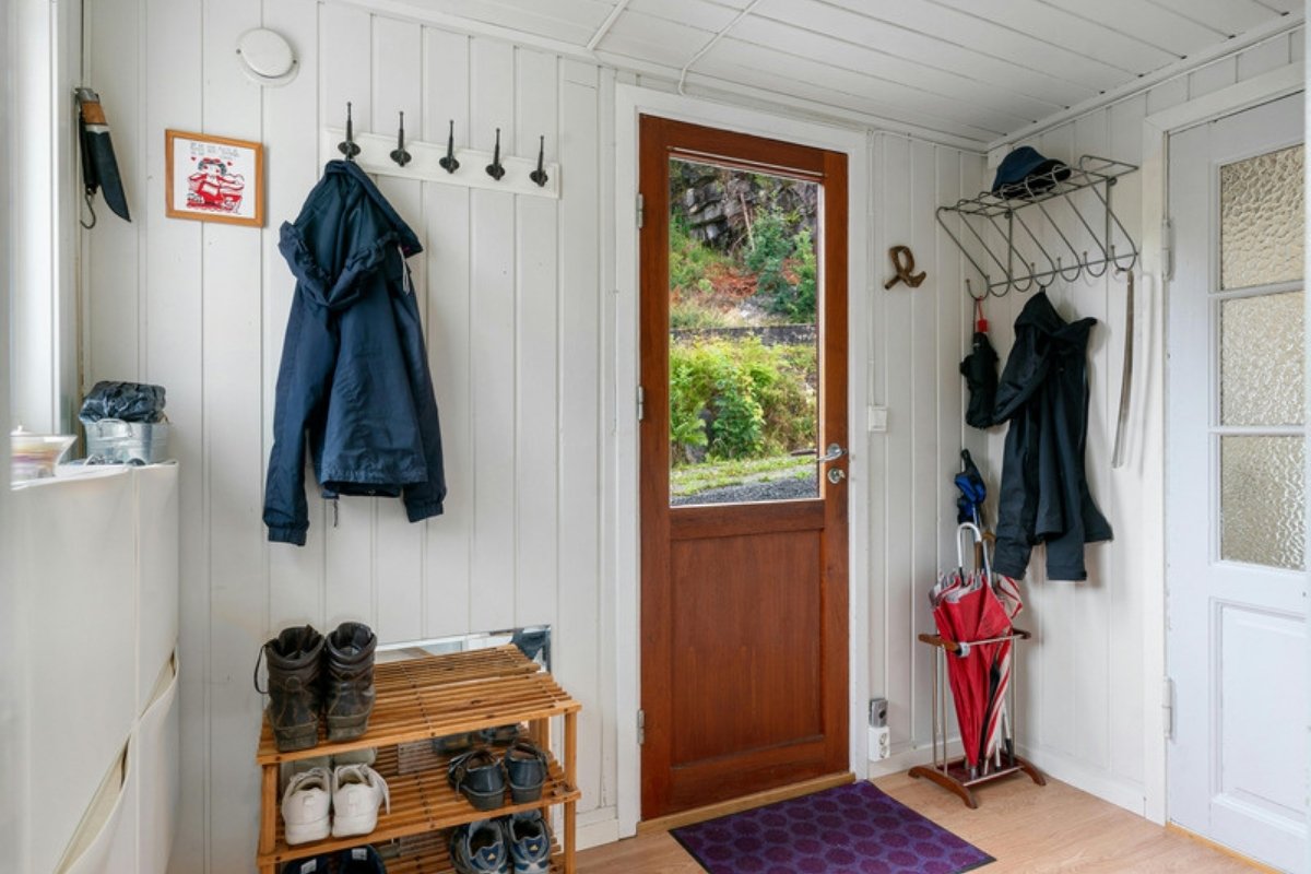 Tidy entryway with coat hooks, a shoe rack and an umbrella stand